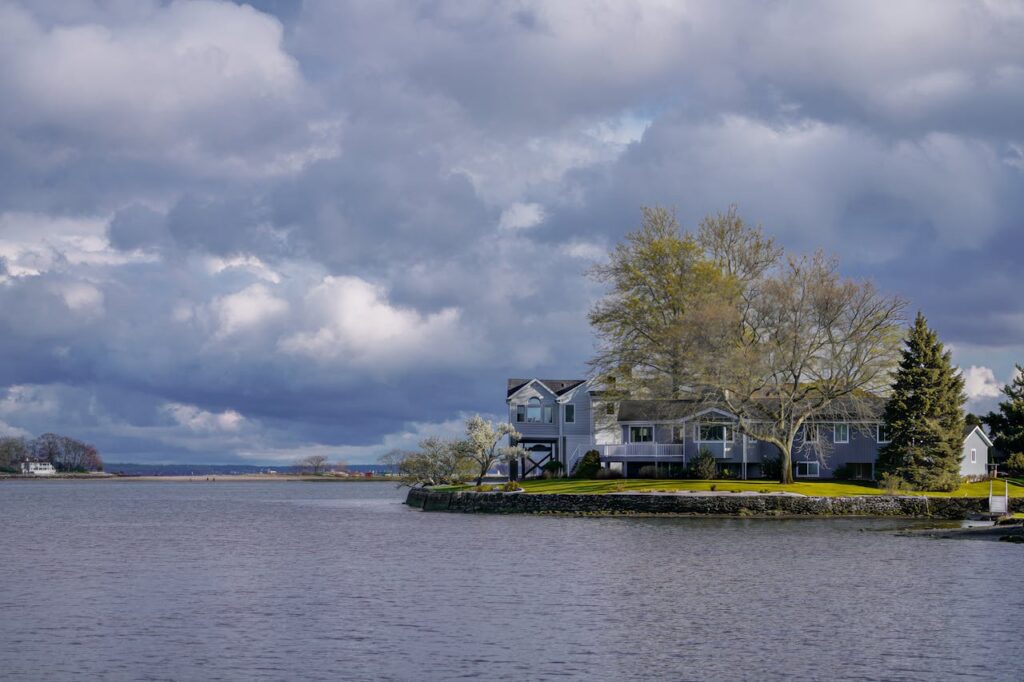 Beautiful waterfront property in Stamford, Connecticut under dramatic clouds, perfect for a tranquil getaway.